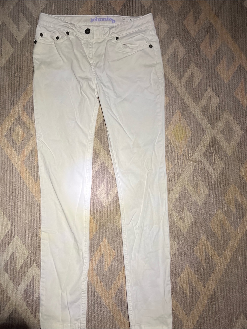 White Johnnie B jeans with black buttons